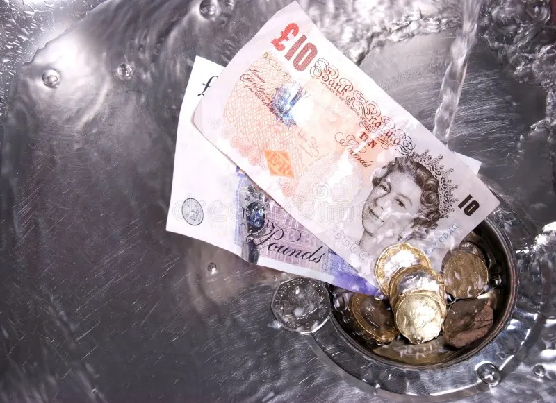 British banknotes and coins illustrating the cost of repeated driving theory tests